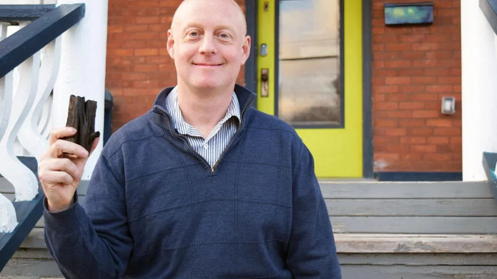 Nate Morris holding biochar in Smiths Falls